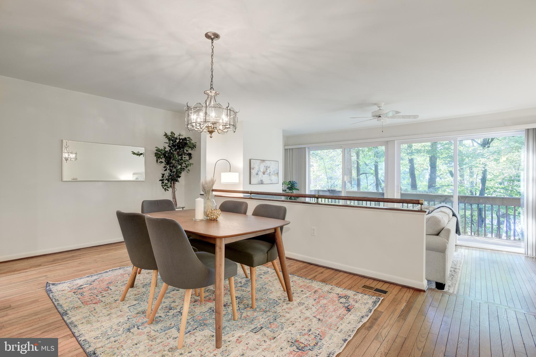2025 Lakebreeze Way Reston, VA 20191 - Photo 11 of 48 a dining room with furniture a chandelier and wooden floor