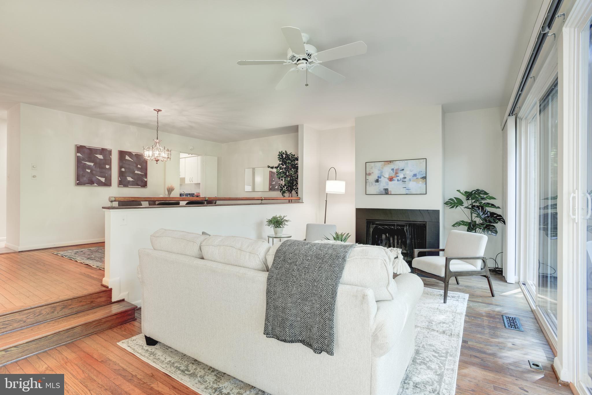 2025 Lakebreeze Way Reston, VA 20191 - Photo 14 of 48 a living room with furniture a fireplace and a flat screen tv