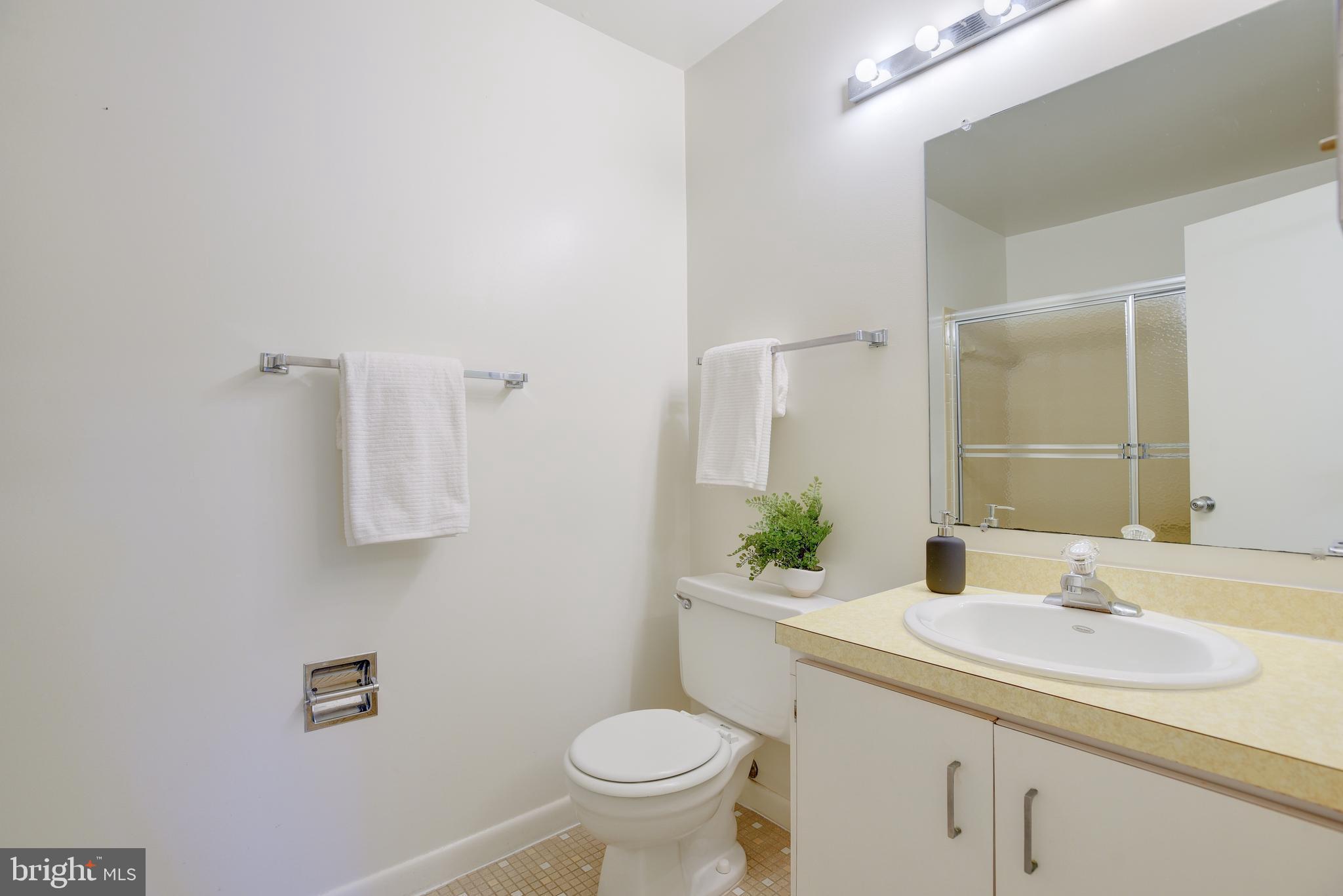 2025 Lakebreeze Way Reston, VA 20191 - Photo 22 of 48 a bathroom with a sink toilet and a mirror