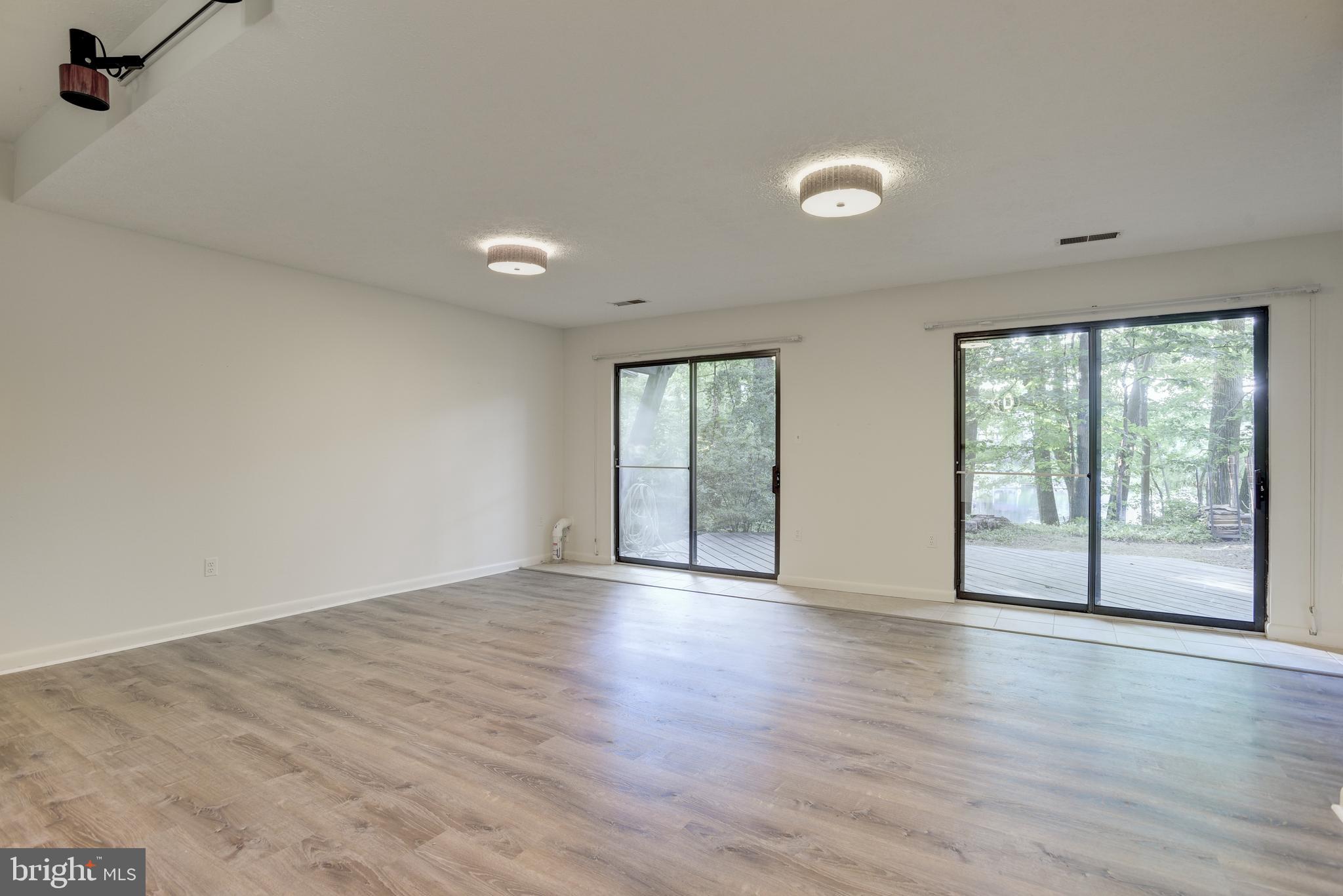 2025 Lakebreeze Way Reston, VA 20191 - Photo 27 of 48 an empty room with wooden floor and windows