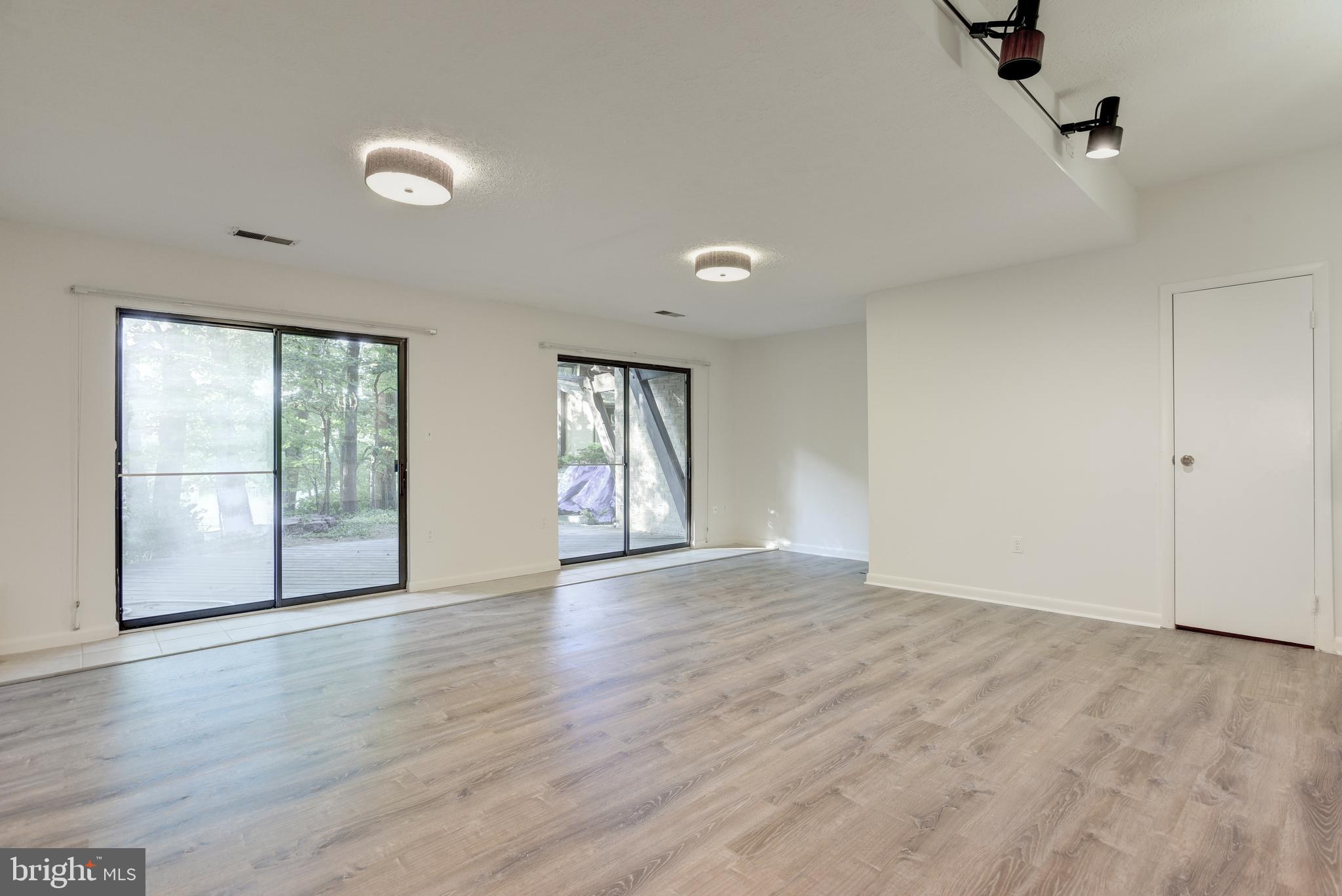 2025 Lakebreeze Way Reston, VA 20191 - Photo 28 of 48 a view of an empty room with glass door and wooden floor