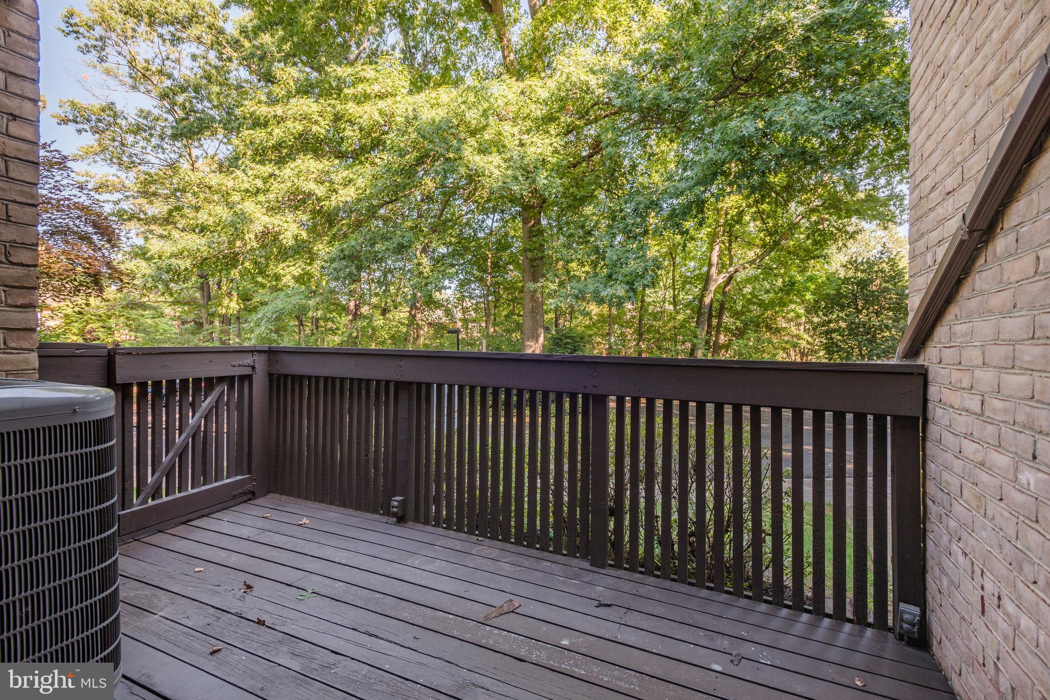 2025 Lakebreeze Way Reston, VA 20191 - Photo 36 of 48 a balcony with wooden floor and fence
