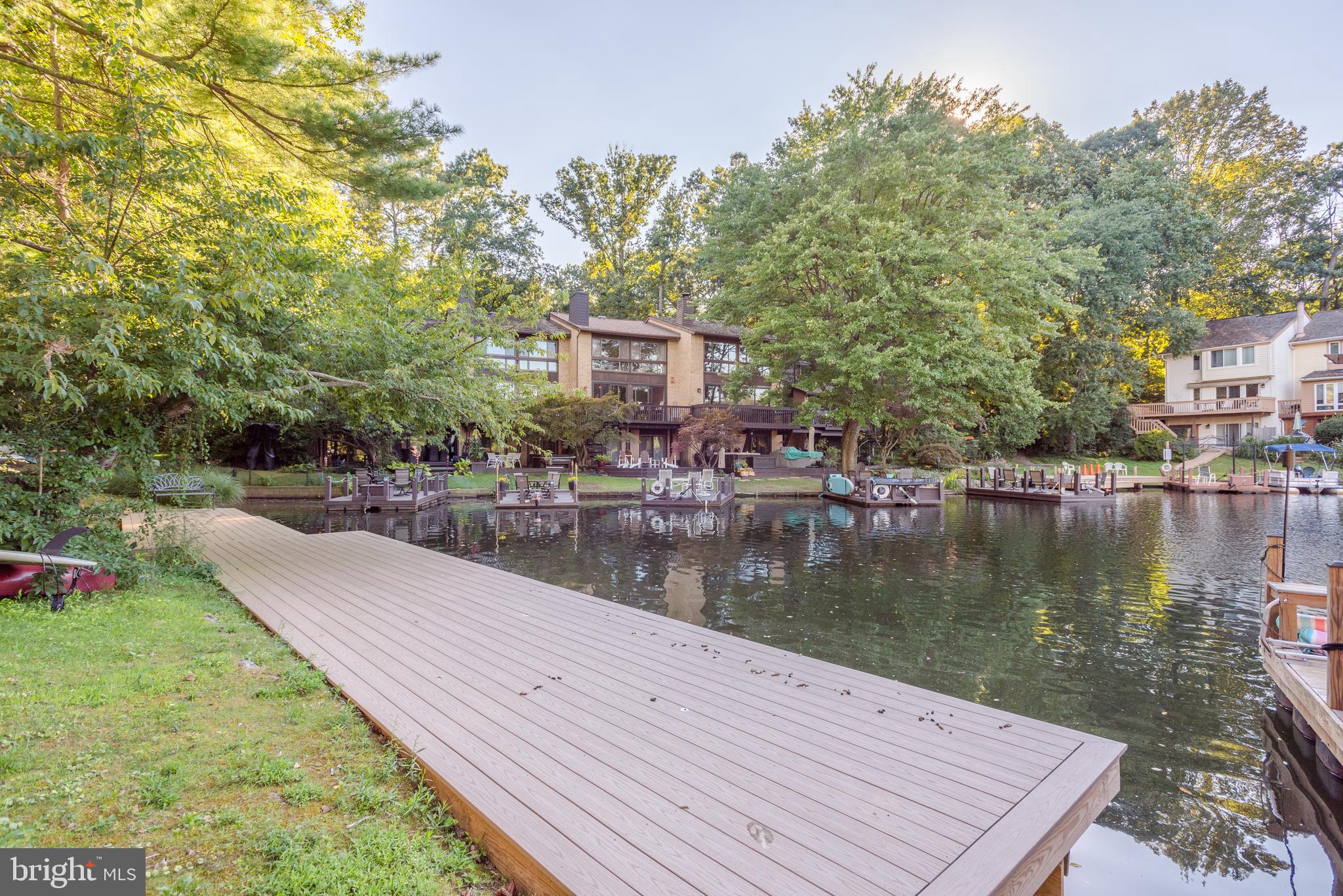 2025 Lakebreeze Way Reston, VA 20191 - Photo 48 of 48 a view of a house next to a lake with a large trees