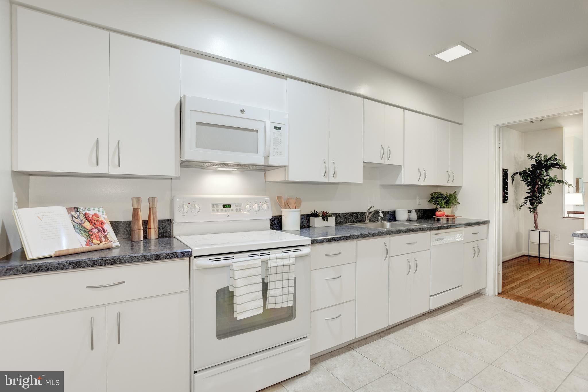2025 Lakebreeze Way Reston, VA 20191 - Photo 7 of 48 a kitchen with granite countertop white cabinets and white appliances