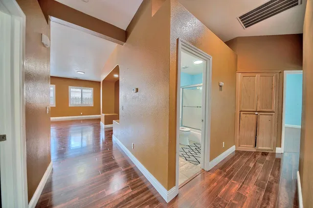 a view of hallway with wooden floor