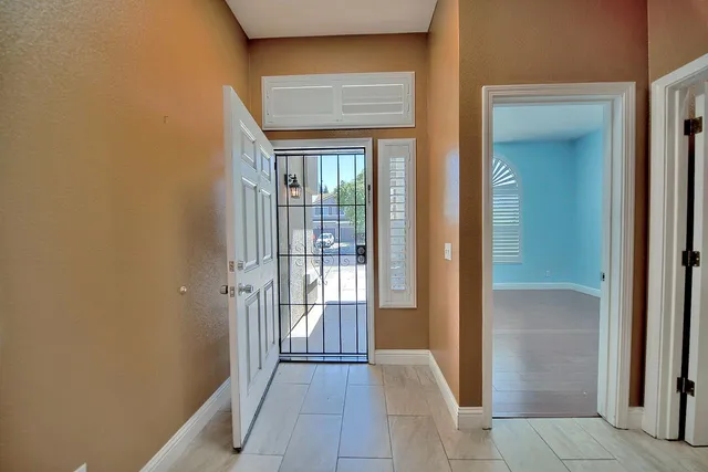 a view of a hallway with a glass door and a window
