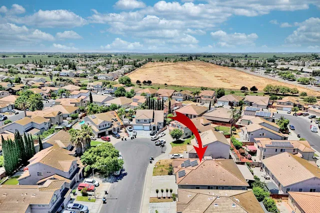 an aerial view of a house with swimming pool and lake view