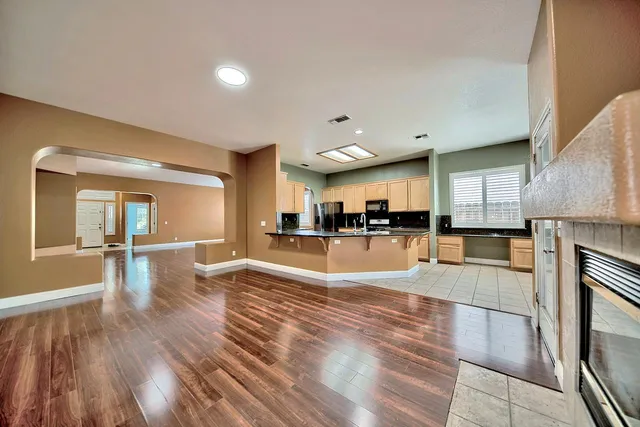 a view of a living room kitchen and a wooden floor
