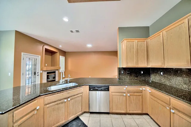 a kitchen with stainless steel appliances granite countertop a sink and cabinets