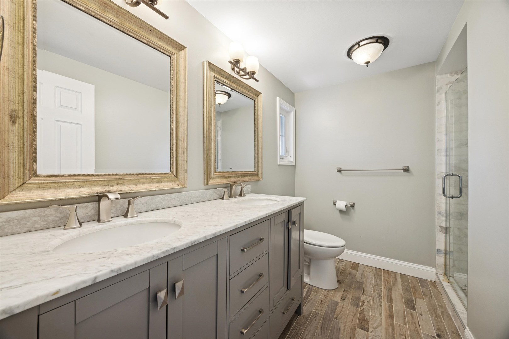 1116 Hidden Spring Drive Naperville, IL 60540 - Photo 16 of 32 a bathroom with a granite countertop sink a toilet and a mirror