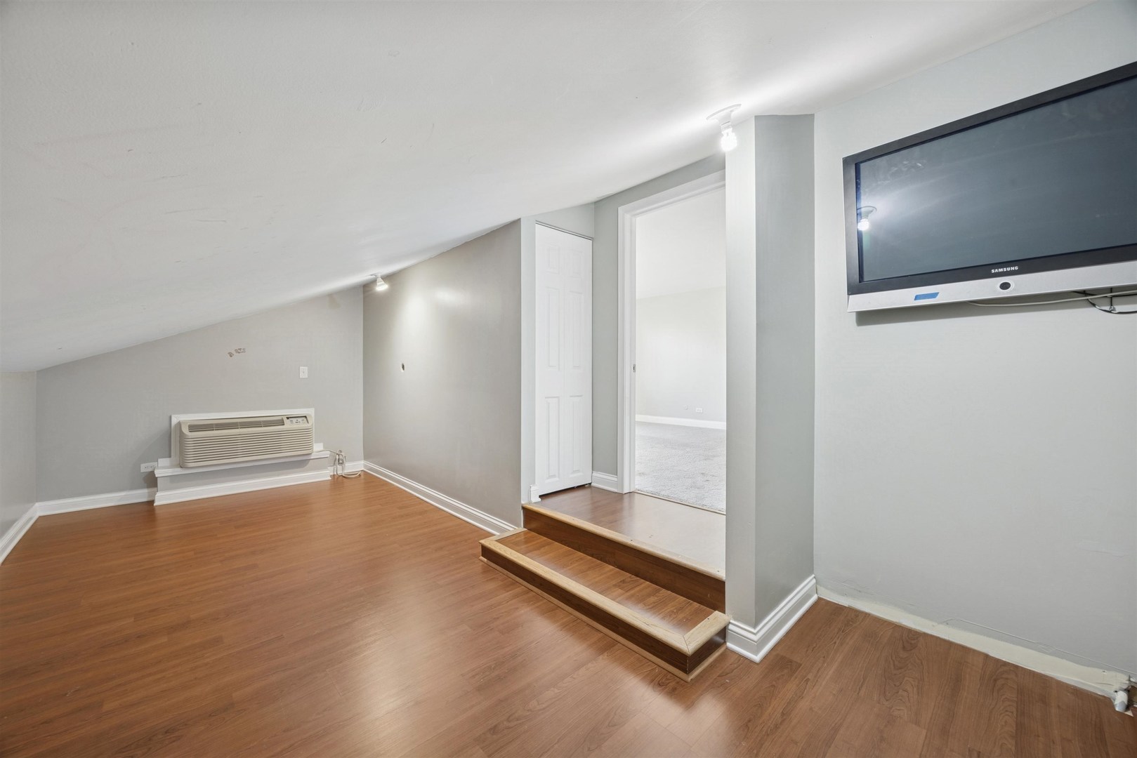 1116 Hidden Spring Drive Naperville, IL 60540 - Photo 18 of 32 a view of an empty room with wooden floor and a window