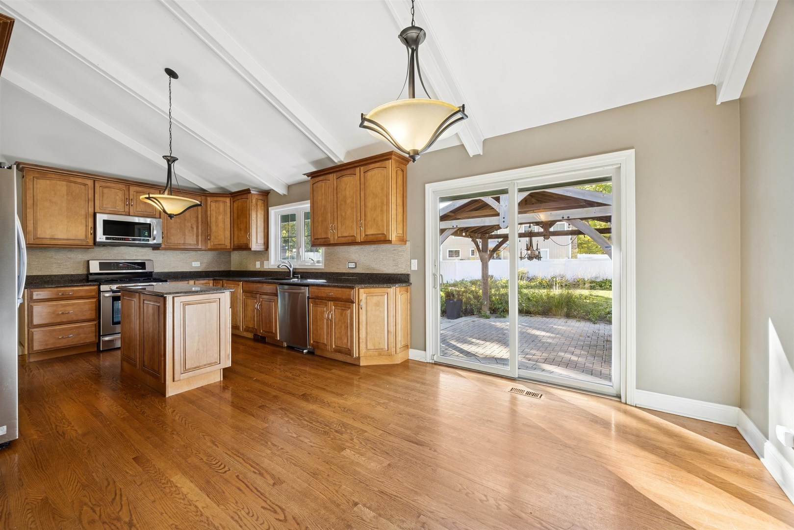 1116 Hidden Spring Drive Naperville, IL 60540 - Photo 6 of 32 a kitchen with stainless steel appliances granite countertop a stove and a refrigerator