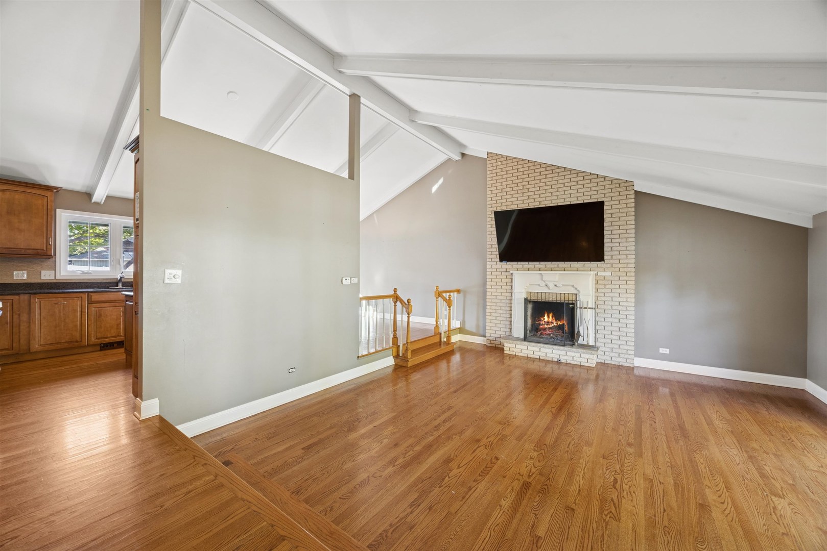 1116 Hidden Spring Drive Naperville, IL 60540 - Photo 7 of 32 a view of empty room with wooden floor and fireplace