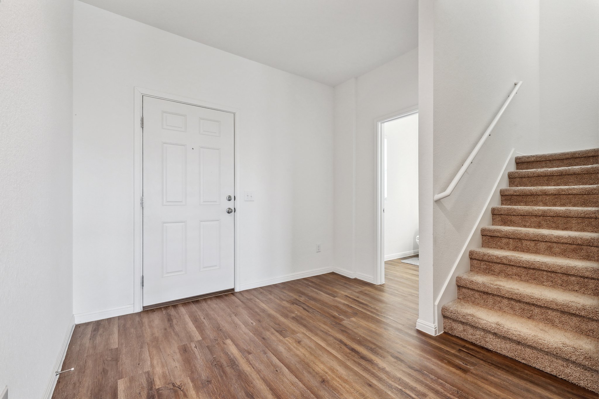 14105 Jeannette Rankin Rd Manor Manor, TX 78653 - Photo 9 of 29 Entryway featuring stairs and wood finished floors