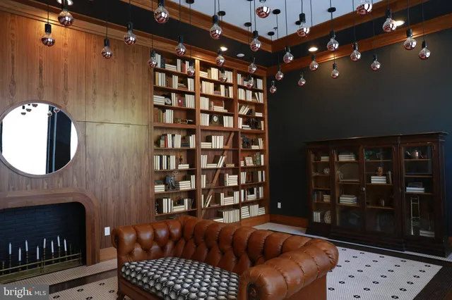 a living room with furniture a rug and a fireplace