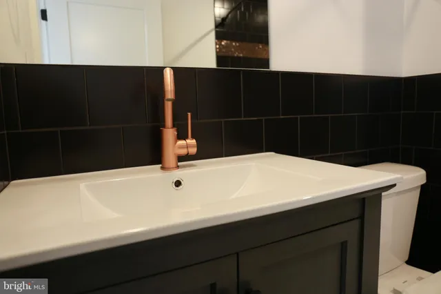 a room with a ceiling fan and a large window