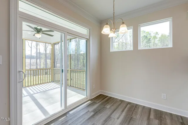 a view of a room with a ceiling fan and a window
