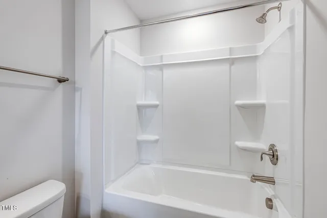 a bathroom with a granite countertop sink a light fixture and a mirror