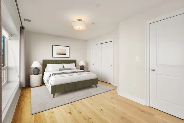 a bedroom with a bed and a painting on the wall