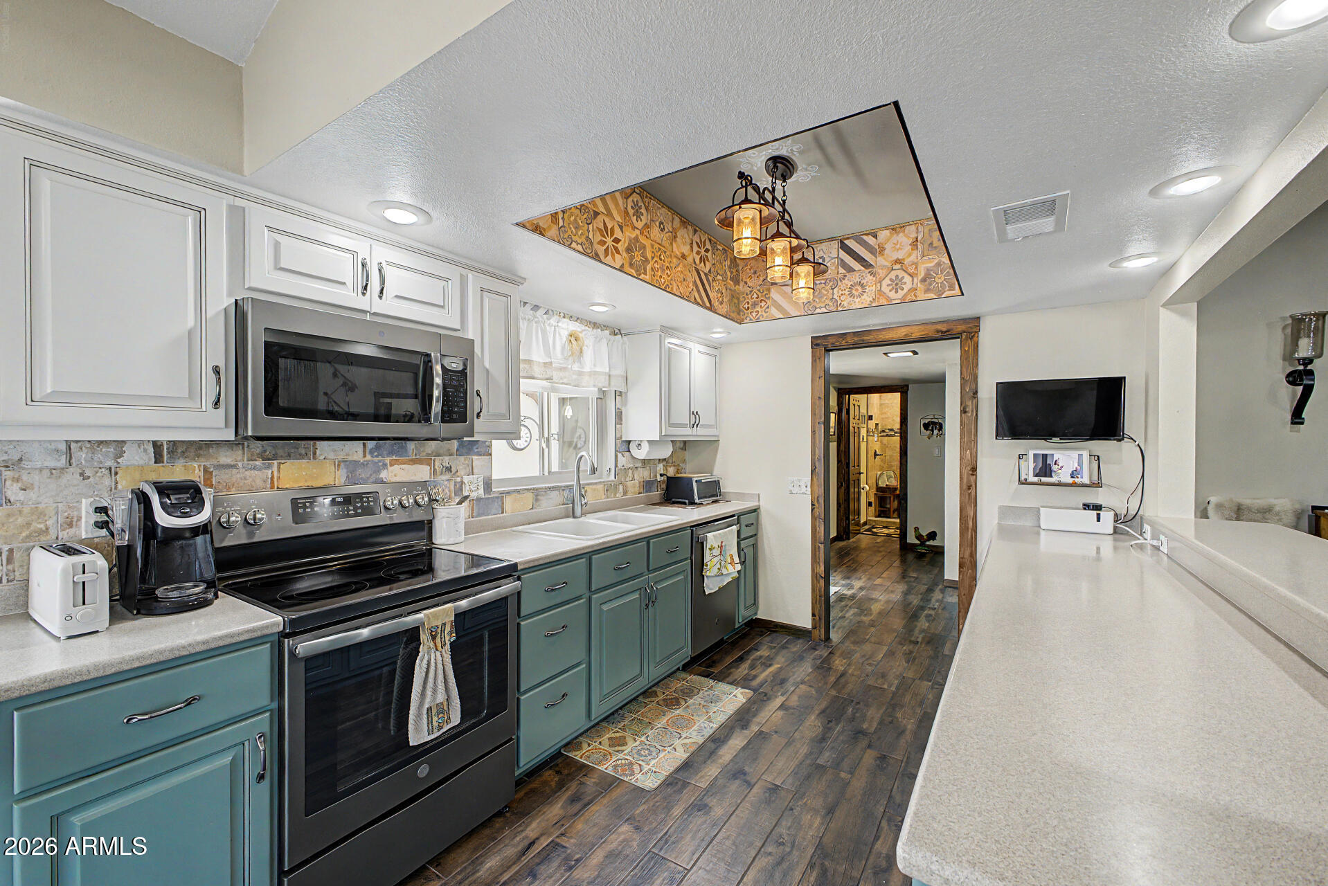18722 East Rio Lane Rio Verde, AZ 85263 - Photo 14 of 55 a kitchen with stainless steel appliances a stove sink microwave and cabinets