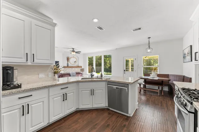 a kitchen with sink cabinets and wooden floor