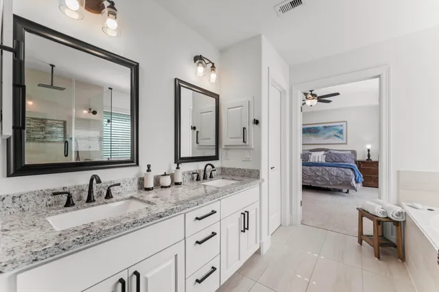 a en suite bathroom with double sink and a mirror