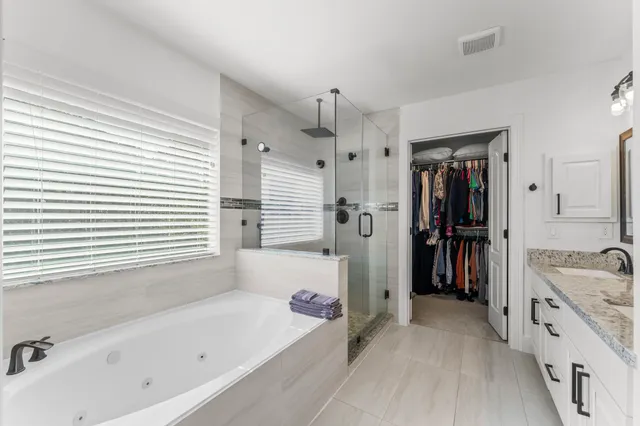 a bathroom with a tub sink and a shower