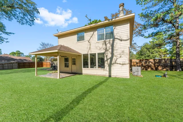 a view of an house with backyard space and porch