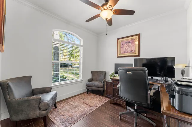 a view of a workspace with furniture and a window