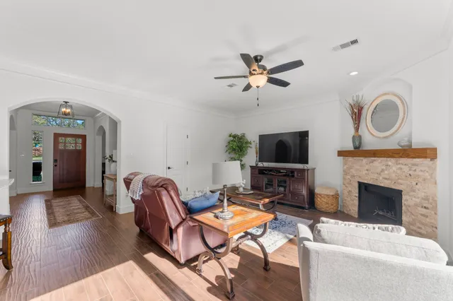 a living room with furniture a flat screen tv and a fireplace
