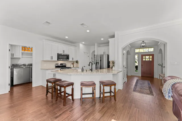 a view of a dining room with furniture and wooden floor