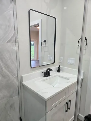 a bathroom with a sink and a mirror
