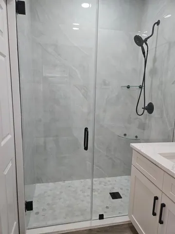a bathroom with a shower and a sink