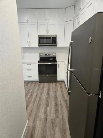 a kitchen with appliances and cabinets