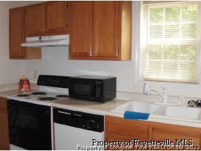 3250 Winesap Road Hope Mills, NC 28348 - Photo 9 of 9 a kitchen with stainless steel appliances granite countertop a sink stove and cabinets