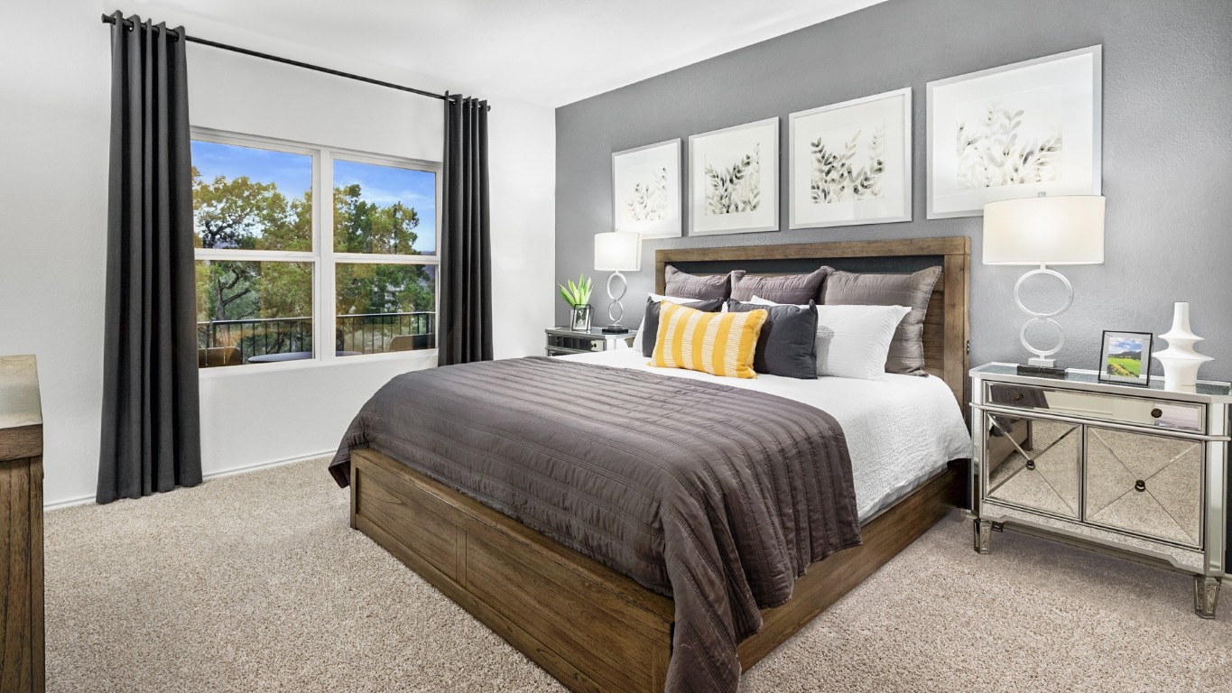 110 Sapling Dew Drive Georgetown, TX 78628 - Photo 21 of 22 a bed sitting in a bedroom next to a window