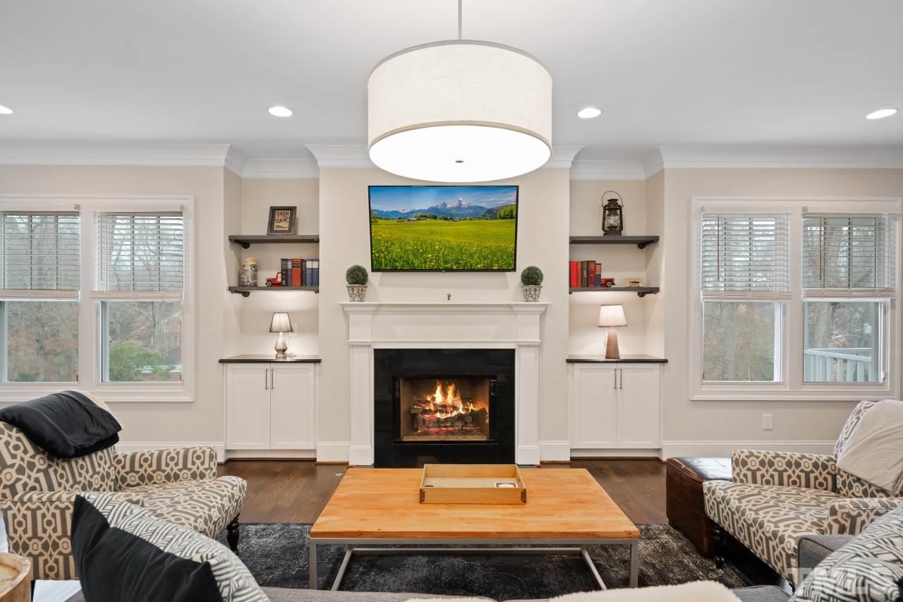 2217 Alexander Road Raleigh, NC 27608 - Photo 13 of 30 a living room with furniture a fireplace and a flat screen tv