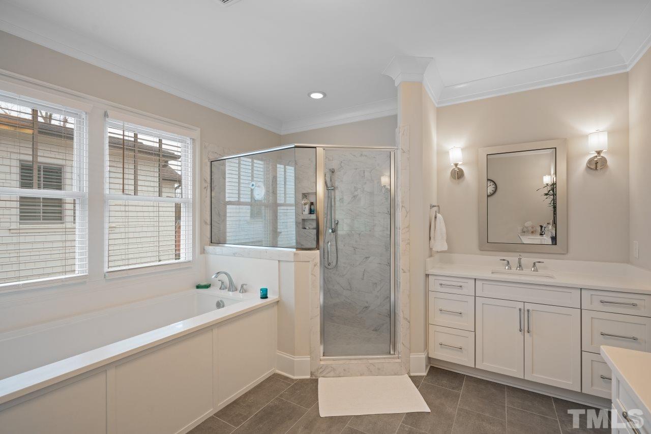 2217 Alexander Road Raleigh, NC 27608 - Photo 21 of 30 a spacious bathroom with a shower tub and a sink