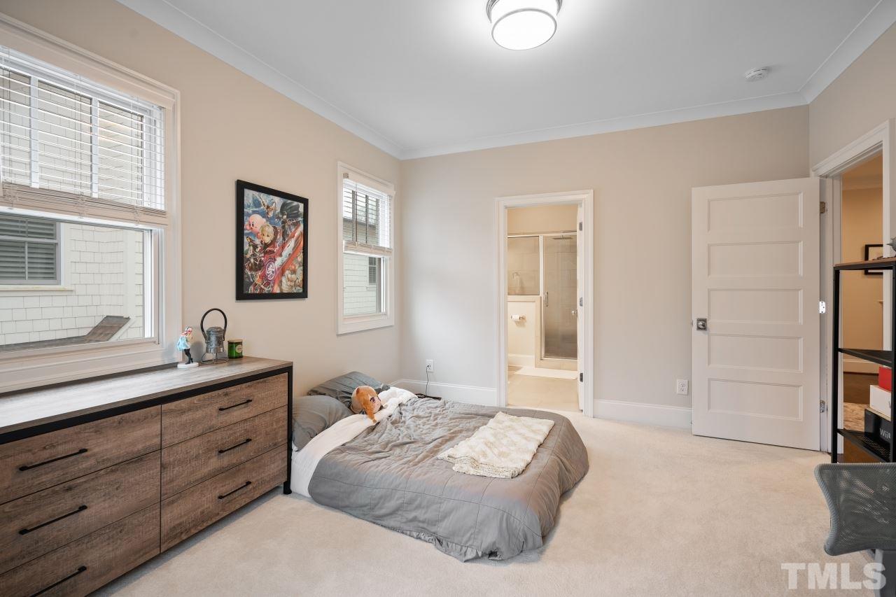 2217 Alexander Road Raleigh, NC 27608 - Photo 22 of 30 a bedroom with a bed and a dresser