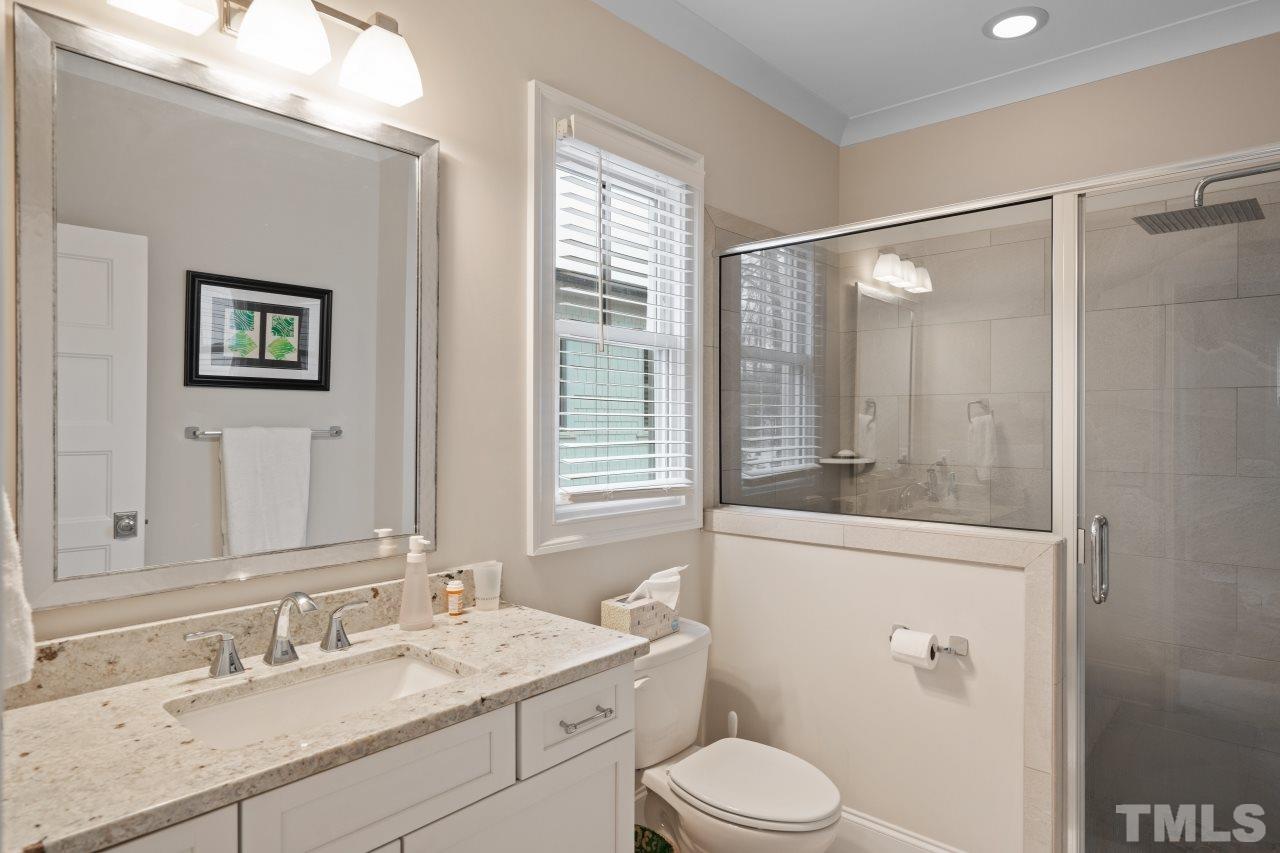 2217 Alexander Road Raleigh, NC 27608 - Photo 23 of 30 a bathroom with a granite countertop sink toilet and shower