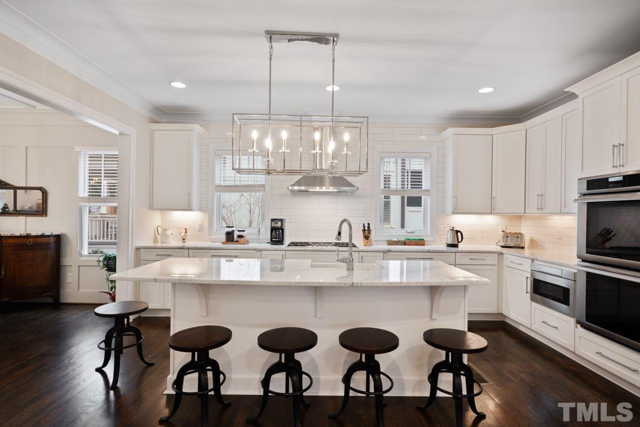 2217 Alexander Road Raleigh, NC 27608 - Photo 8 of 30 a large kitchen with a table and chairs in it