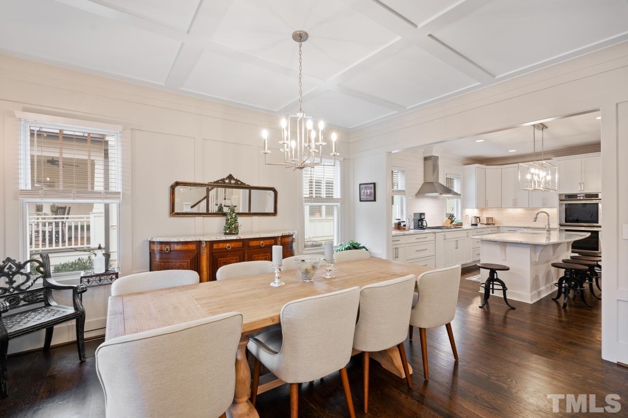 2217 Alexander Road Raleigh, NC 27608 - Photo 9 of 30 a view of a dining room with furniture a chandelier and wooden floor