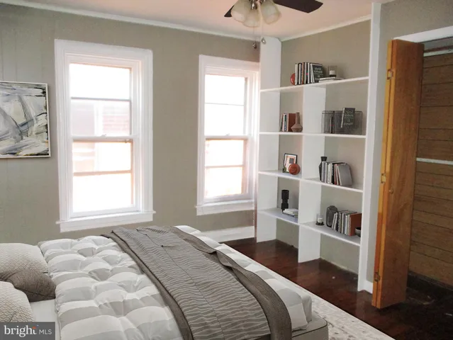 a bedroom with a bed and a window