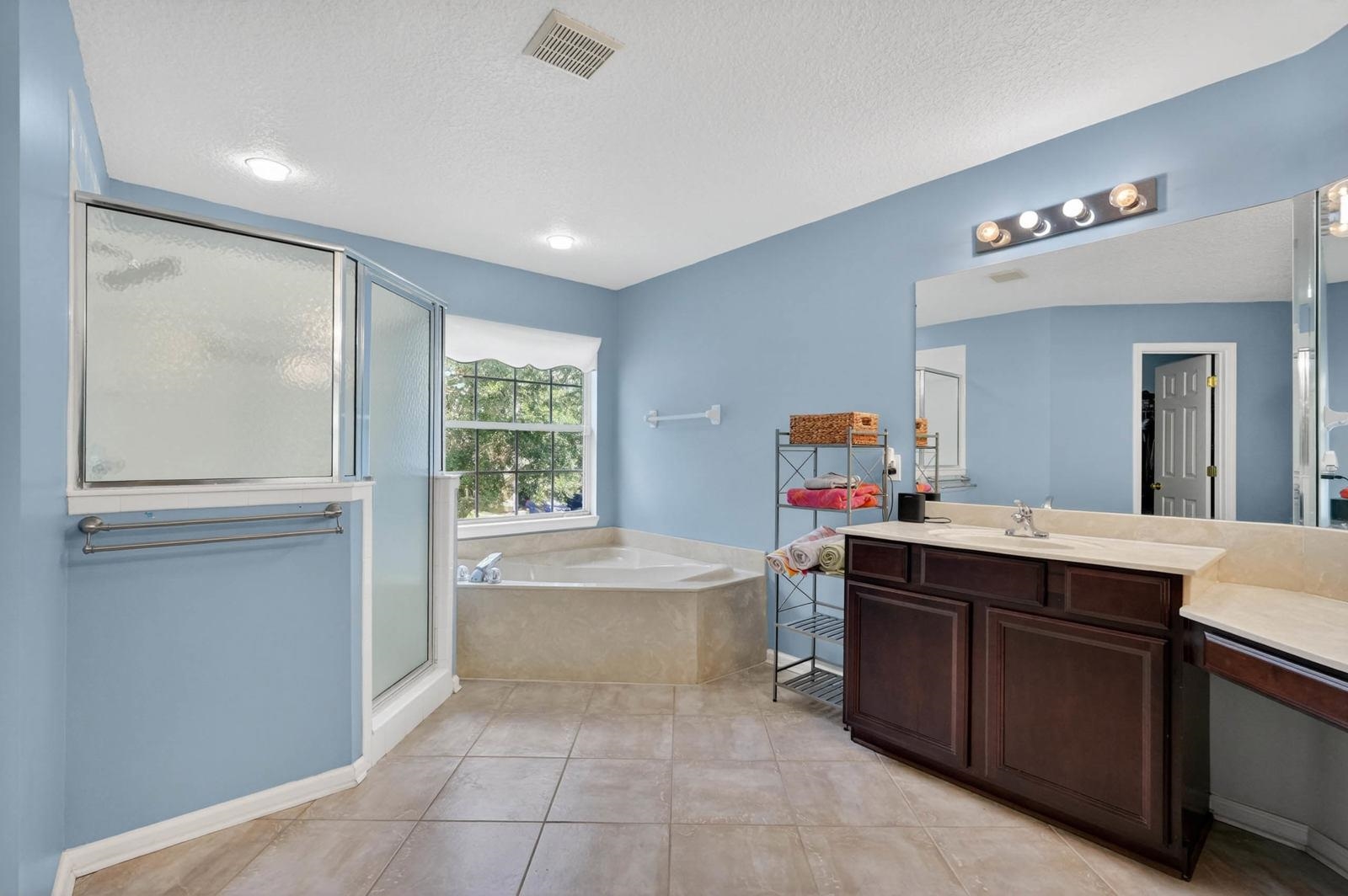 1237 Splendid Ravine Street St. Augustine, FL 32092 - Photo 23 of 62 a spacious bathroom with a tub sink and mirror