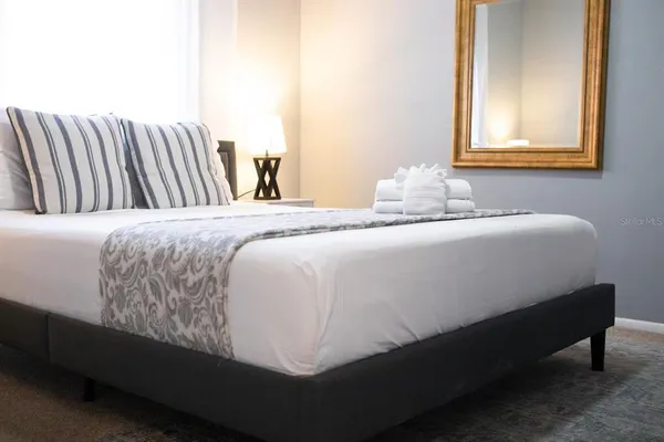 a bedroom with a bed and window