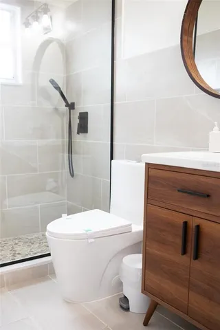 a white toilet sitting next to a bathroom sink