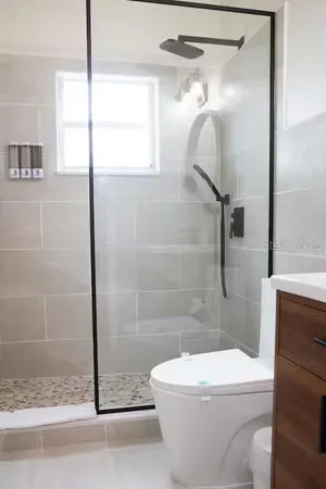 a white toilet sitting next to a bathroom sink