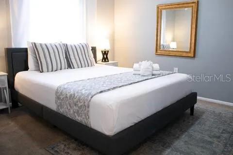 a bedroom with bed and window