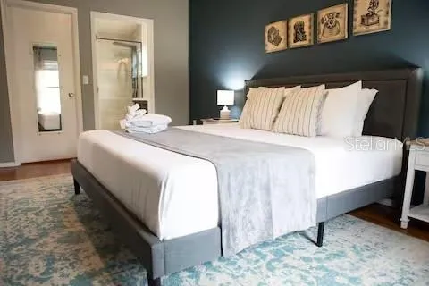 a bedroom with a bed and a mirror