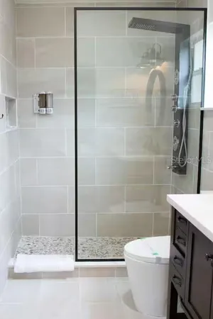 a bathroom with a shower a toilet and a sink